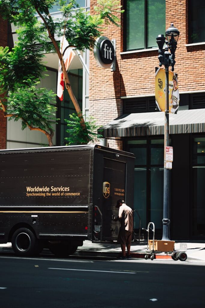 Crafting Captivating Headlines: Your awesome post title goes here UPS delivery courier loading packages into truck on urban street, showcasing transportation and logistics.